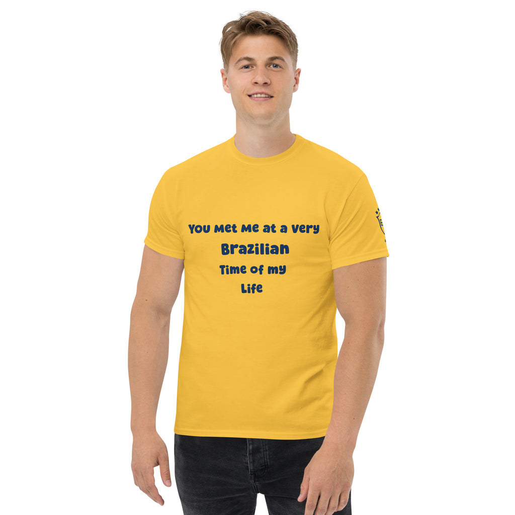 Front view of a model wearing a yellow graphic tee with black lettering and a sleeve emblem