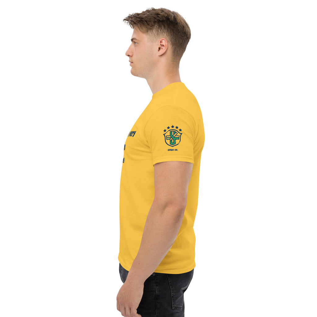 Side view of the yellow classic tee showing its blue-and-green sleeve emblem