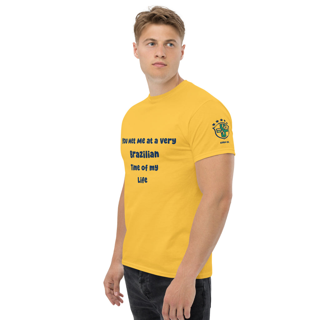 Three-quarter front view of a model wearing a yellow graphic tee with black lettering
