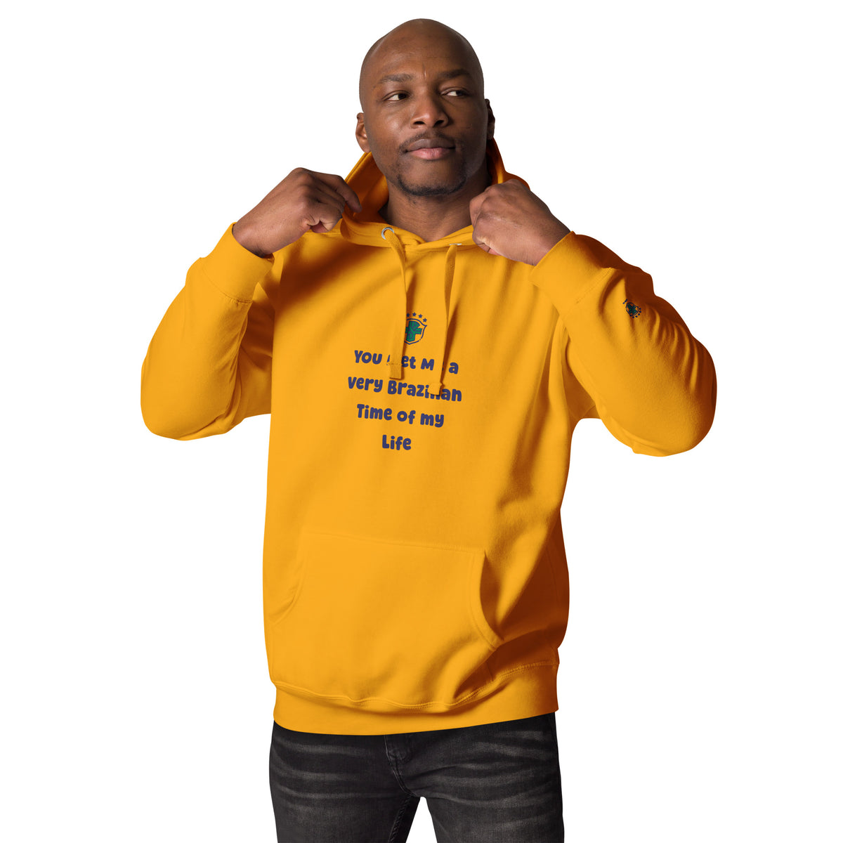 Front view of a model wearing a gold graphic hoodie with black slogan lettering